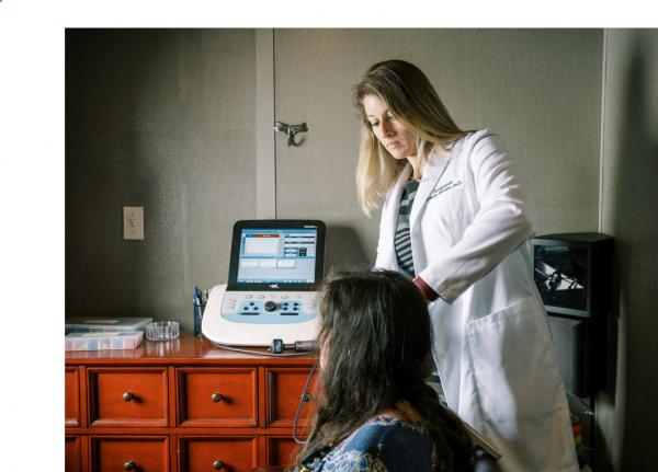 Dr. Breeden  attending a patient