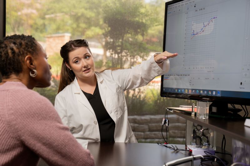 An audiologist reviews an audiogram with a patient.