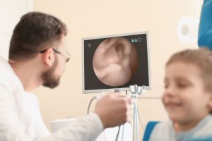 A child receives an ear exam. 