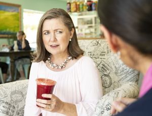 A woman struggles to hear. 