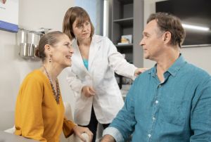 An audiologist assures a patient.