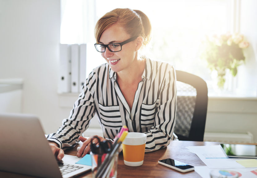 A woman working at her laptop.